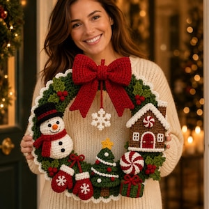 May include: A round crochet Christmas wreath featuring a large red bow at the top, a white snowflake ornament, a snowman, a gingerbread house, a green Christmas tree, red mittens, a peppermint candy, and a green gift box with red ribbon.