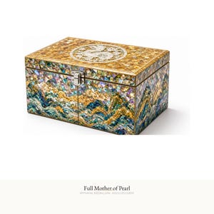 May include: A rectangular chest featuring an intricate mother of pearl mosaic in shades of gold, blue, and green. The lid displays a circular dragon medallion, while the front depicts a landscape of waves and mountains with a silver metal latch.