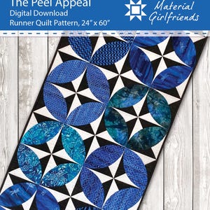 May include: A runner quilt pattern with a geometric design. The quilt features blue and teal fabric in a circular pattern, with black and white accents. The text "The Peel Appeal" and "Material Girlfriends" is visible.