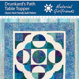 May include: A quilt pattern for a Drunkard's Path table topper. The pattern is charm-pack friendly and features a white background with blue, green, and purple fabric circles and arcs. The pattern is titled "Drunkard's Path Table Topper" and is by Material Girlfriends.