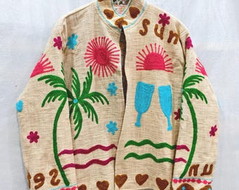 May include: A beige long-sleeve jacket featuring colorful embroidered designs of palm trees, suns, blue glasses, and hearts. The word "sun" is embroidered on the right chest, and the number "92" is embroidered on the left sleeve cuff.