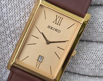 Vintage Seiko quartz tank gouden wijzerplaat datumvenster goudkleurig rechthoekig gerenoveerd horloge