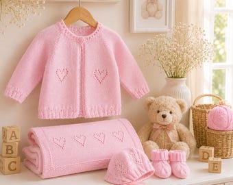 May include: A light pink knitted baby set featuring a long-sleeve cardigan with a single button, a matching blanket with heart-shaped eyelet patterns, a bonnet with ribbon ties, and a pair of cabled booties, all crafted in a soft yarn.
