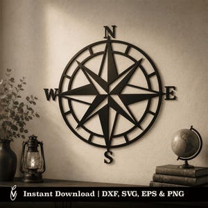 May include: A black metal compass rose wall art piece featuring a central star design with cardinal direction letters N, E, S, and W. The circular frame has segmented detailing. The text at the bottom reads: Instant Download | DXF, SVG, EPS & PNG.