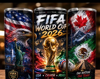 Pode incluir: Três copos cilíndricos com gráficos da Copa do Mundo FIFA 2026. Os designs incluem a bandeira americana, uma águia-de-cabeça-branca, a Estátua da Liberdade, o troféu da FIFA, uma bola de futebol, a bandeira canadense e a bandeira mexicana.