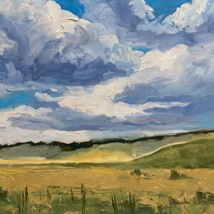 Original New Mexico landscape oil painting Under a High Country August Sky by Santa Fe artist Dawn Chandler, showing a vast golden meadow, rolling green hills, and a dramatic late‑summer sky filled with thick blue and white clouds, painted with expressive impasto brushstrokes that capture shifting light and shadow across the high‑country terrain.