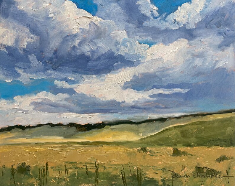 Original New Mexico landscape oil painting Under a High Country August Sky by Santa Fe artist Dawn Chandler, showing a vast golden meadow, rolling green hills, and a dramatic late‑summer sky filled with thick blue and white clouds, painted with expressive impasto brushstrokes that capture shifting light and shadow across the high‑country terrain.