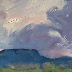 Upper-section detail of Abiquiu Field of Summer Gold, an original New Mexico landscape oil painting by Santa Fe artist Dawn Chandler, emphasizing dramatic lavender and blue storm clouds rolling above distant blue mesas and mountains green tree tops, evoking changing weather in the Rio Chama valley.