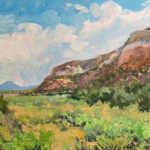 Original New Mexico landscape oil painting “Finding My Way to Pedernal” by Santa Fe artist Dawn Chandler, featuring Pedernal’s blue silhouette beyond sunlit Abiquiu mesas, sweeping green valley grasses, distant cottonwoods and expressive clouds painted with lively, textured brushstrokes; an atmospheric Southwest scene by contemporary landscape painter Dawn Chandler.