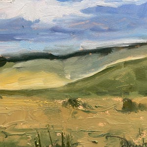 Close‑up view of Dawn Chandler’s original New Mexico landscape painting Under a High Country August Sky, highlighting the rolling green hillside and golden high‑country field with thick, directional brushstrokes, scattered sagebrush forms, and soft shadows receding toward a dark tree line under a layered sky of blue, lavender, and creamy clouds.