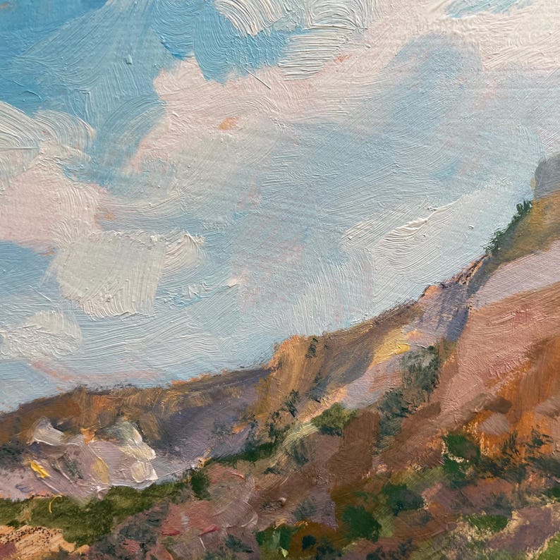 Detail of original New Mexico landscape painting by Santa Fe artist Dawn Chandler, showing the upper rim of warm ochre and lavender mesa cliffs catching late-day light beneath a vast New Mexico sky of soft blue and pale peach clouds, revealing the expressive impasto brushwork and color harmonies of “Finding My Way to Pedernal.