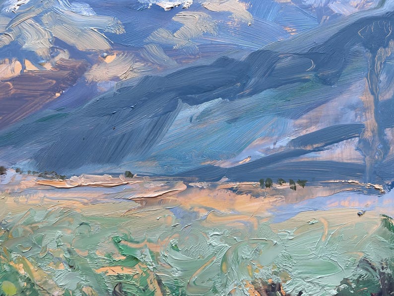 Detail from original New Mexico landscape painting Spring Morning Over the Taos Mountains by Santa Fe artist Dawn Chandler, highlighting the rolling mid-distance slopes painted in layered blues, olives, and warm umbers, with a narrow band of sunlit fields and tiny tree marks at the base of the mountains, all above thick, swirling strokes of green foreground grasses that convey movement and depth in the Taos valley.