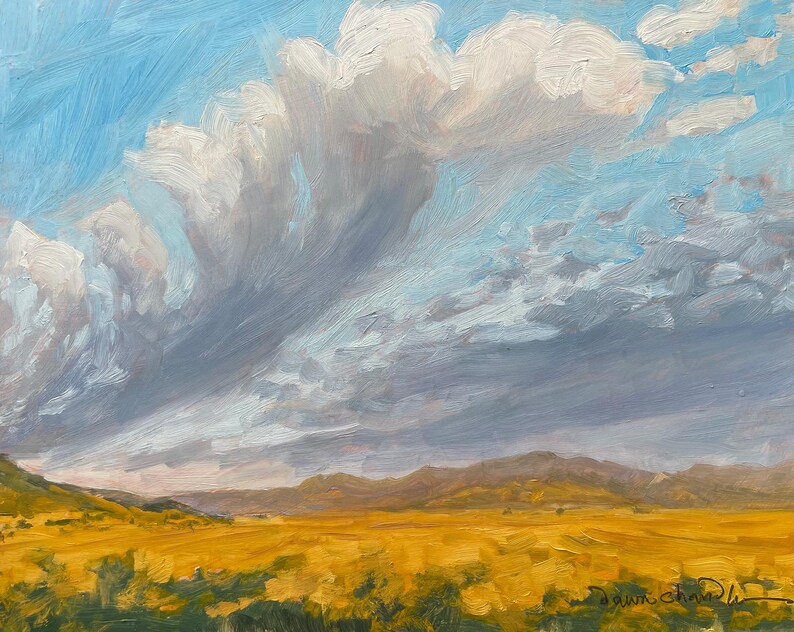 October Morning Along Miami Lane, original New Mexico landscape painting in oil by Santa Fe artist Dawn Chandler, portrays the golden fields and soft morning clouds of Miami, New Mexico. Bathed in the pure light of autumn, the view looks west toward the Sangre de Cristo Mountains of Philmont, glowing beneath expansive blue skies.