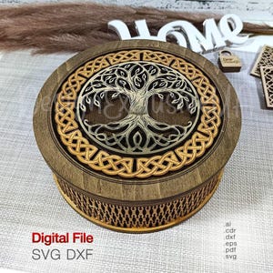 May include: A round wooden box featuring a laser-cut tree of life design on the lid, surrounded by a decorative Celtic knot border. The sides of the box have a repeating geometric pattern. Text on the image reads Digital File SVG DXF.