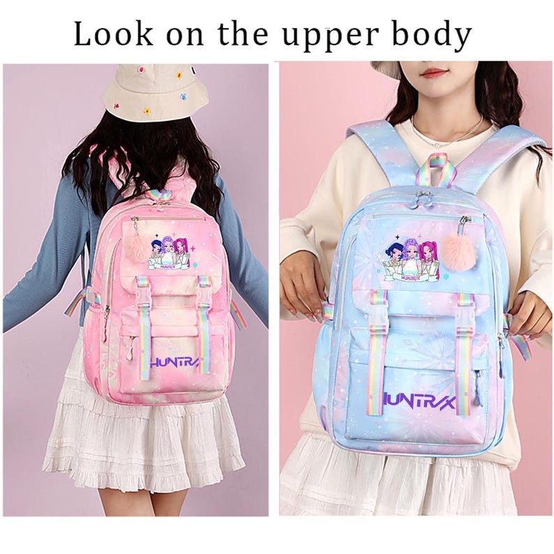 May include: A backpack featuring a gradient color scheme with a graphic of three figures and the text "HUNTRAX". The bag includes adjustable rainbow-striped straps, a front pocket with buckle closures, and a fluffy pom-pom charm attached to the zipper.