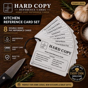 May include: A set of eight double-sided white PVC reference cards held together by a black ring. The cards feature black text and icons, including titles like Measurement Conversions, Cooking Temps & Safety, and Baking Basics, with the Hard Copy logo.