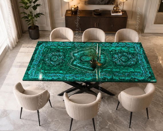 A custom-poured luxury dining table with swirling emerald malachite epoxy rivers — no two are ever the same.