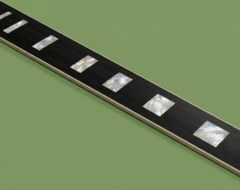 May include: A guitar fretboard featuring a dark wood surface with rectangular mother-of-pearl inlays positioned along the length of the neck. The fretboard includes thin metal frets and a light-colored binding along the side edges of the neck.