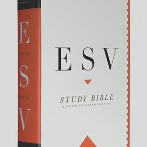 May include: A hardcover ESV Study Bible with a white cover featuring black text that reads ESV and STUDY BIBLE ENGLISH STANDARD VERSION. The spine is orange with black accents and the text ESV. There are orange triangle graphics on the front cover.