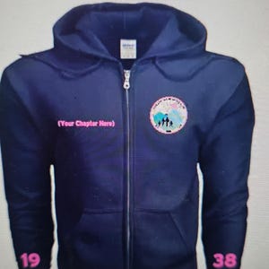 May include: Navy blue zip-up hoodie with a hood and front pockets. The hoodie features a circular patch with a family silhouette and text that reads "(Your Chapter Here)". Pink numbers "19" and "38" are printed on the bottom of the hoodie.