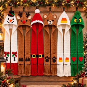 May include: Six crocheted hooded scarves hanging in a row. Designs include a snowman, a reindeer, a Santa suit, a bear, a candy corn pattern, and a green character with yellow eyes. Each scarf features long fringe at the ends.