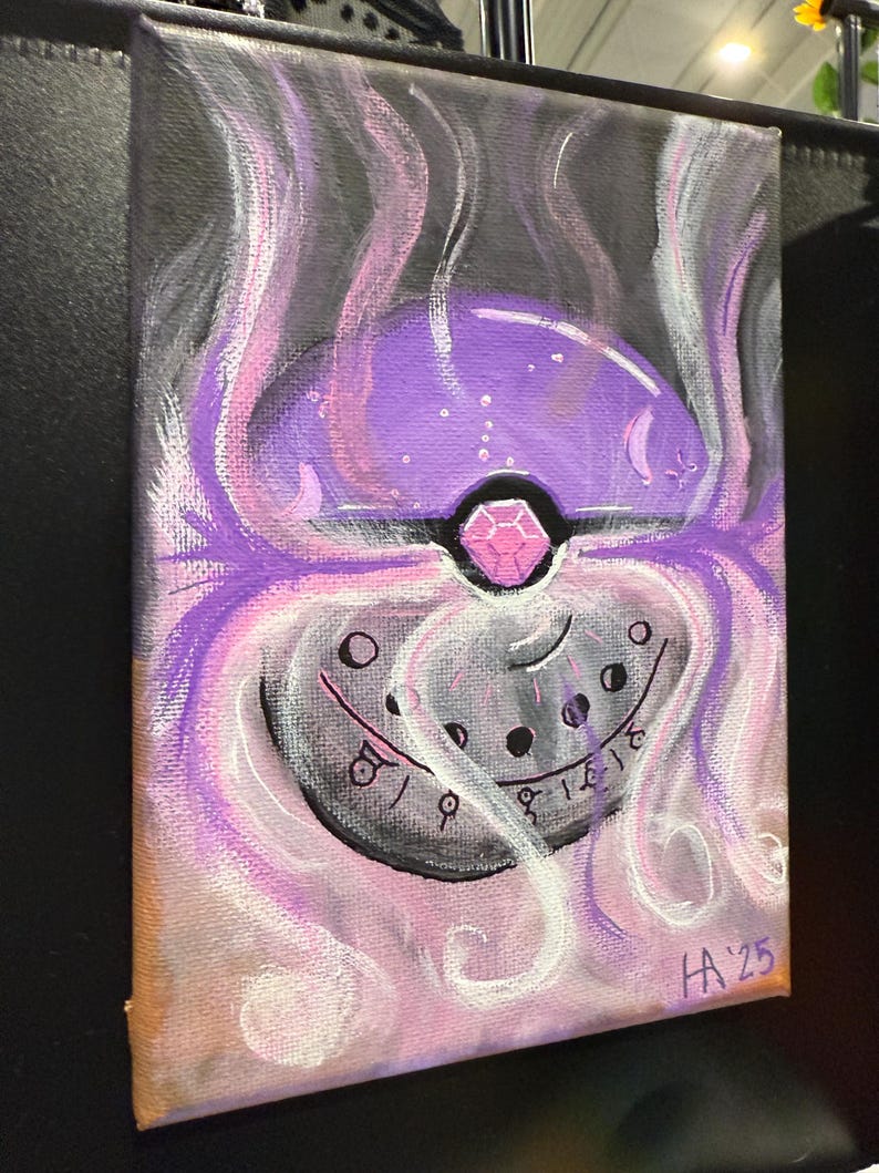 May include: A purple and black painted canvas with a stylized image of a Pokeball. The Pokeball is surrounded by white and pink swirls. The Pokeball has a pink gem in the center and a black and white design around the outside. The canvas is signed "HA'25" in the bottom right corner.