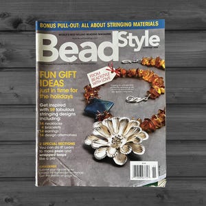 May include: The November 2008 issue of BeadStyle magazine features a cover with the text BeadStyle, Fun Gift Ideas, and Bonus Pull-Out. A necklace with amber-colored beads, a blue pendant, and a large silver flower-shaped focal piece is shown.