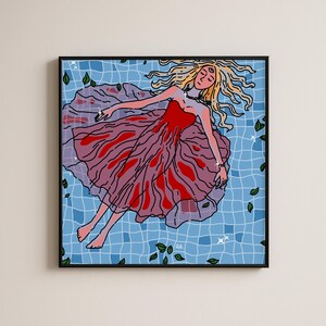 May include: A square framed art print featuring a stylized illustration of a figure with long blonde hair and a third eye on their forehead, floating in a blue tiled pool. The figure wears a red and purple dress, surrounded by scattered green leaves.