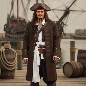 May include: A pirate costume featuring a brown long coat, a white collared shirt, a dark waistcoat, and black trousers. The outfit includes a brown tricorn hat, a red headscarf, a brown leather-style shoulder belt with a buckle, and a waist sash.
