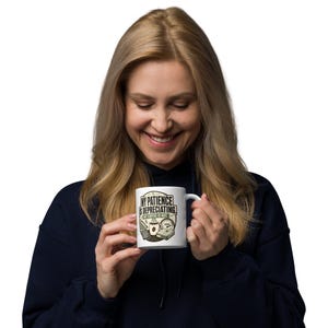 May include: A white ceramic mug featuring a graphic design with the text "MY PATIENCE IS DEPRECIATING. MY COFFEE IS NOT." The illustration includes a coffee cup, a calculator, a downward trending graph, a percentage symbol, and a gauge.