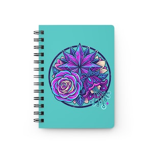 May include: A spiral-bound notebook with a teal cover featuring a circular graphic. The design includes a central purple star-shaped element surrounded by a detailed rose and a fuchsia-like flower in shades of vibrant purple, blue, and pink.