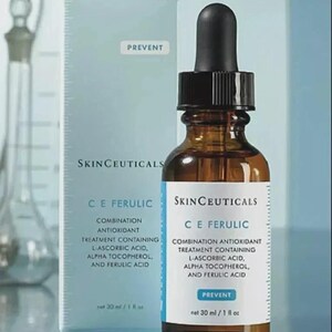 May include: A brown glass dropper bottle and a light blue box of SkinCeuticals C E Ferulic combination antioxidant treatment. The label and box text list L-ascorbic acid, alpha tocopherol, and ferulic acid. The volume is 30 ml / 1 fl oz.