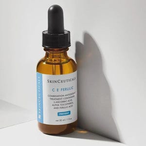 May include: An amber glass bottle of SkinCeuticals C E Ferulic combination antioxidant treatment. The white label features blue accents and text including L-Ascorbic Acid, Alpha Tocopherol, and Ferulic Acid. It has a black dropper cap and is 1 fl oz.