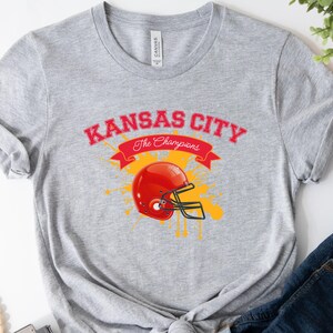 a kansas city football helmet on a gray shirt