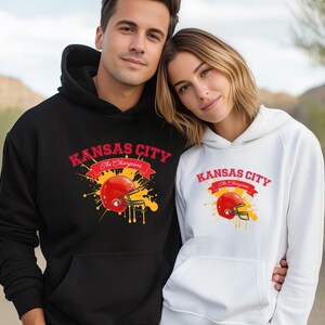 a man and a woman wearing kansas city hoodies