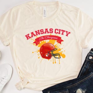 a white shirt with a football helmet on it