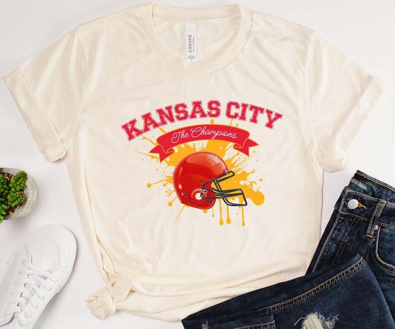 a white shirt with a football helmet on it