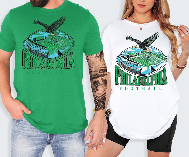 two people wearing Philadelphia Football t-shirts, one in a green shirt and the other in a white shirt.