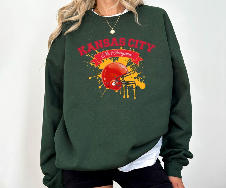 a woman wearing a green sweatshirt with a football helmet on it
