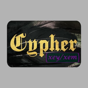 May include: Gold lettering on a black background reads "Cypher" with the text "xey/xem" in a green rectangle with a purple border.