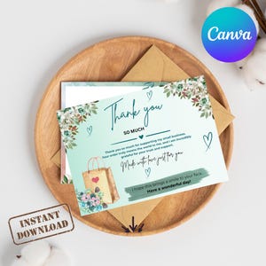 May include: A rectangular thank you card with a light mint green background, featuring floral illustrations, a brown shopping bag graphic, and dark blue text that reads Thank you SO MUCH, Made with love just for you, and Have a wonderful day.