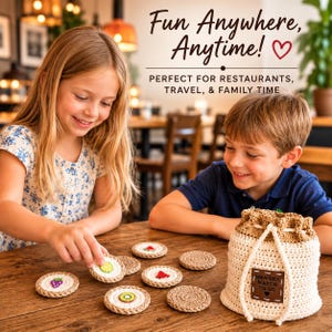 May include: A memory match game featuring circular crocheted tokens with fruit designs and a matching drawstring storage bag. The bag is cream and tan with a brown leather-like patch that reads "MEMORY MATCH TO-GO" with a small heart icon.
