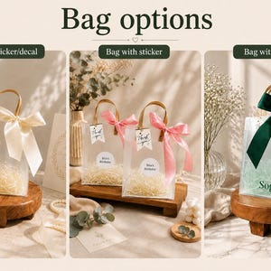 May include: A collection of clear gift bags with handles, displayed in three variations: one with a cream ribbon, two with pink ribbons and circular stickers, and one with a dark green ribbon and the name Sophia printed in dark green text.