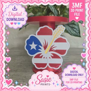 May include: A 3D printed hibiscus flower ornament featuring the Puerto Rican flag design with a white star on a blue petal and red and white stripes on other petals. The center includes a yellow stamen. Text reads 3MF 3D PRINT FILE and DIGITAL DOWNLOAD.