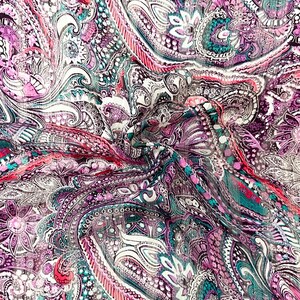 May include: A lightweight fabric featuring a dense, intricate paisley pattern in shades of magenta, deep purple, teal, and white. The material displays a complex, swirling design with floral motifs and fine line work throughout the textile surface.