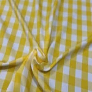May include: A fabric featuring a classic yellow and white gingham check pattern. The material is draped to show soft folds and ripples, highlighting the consistent grid design of the checkered textile across the surface of the folded cloth.