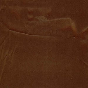 May include: A solid dark brown surface with a smooth, matte texture. The material displays subtle, organic folds and creases across the frame, creating a uniform monochromatic appearance with soft shadows that define the depth of the surface.