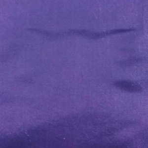 May include: A solid, deep purple fabric surface with a smooth, matte texture. The material displays subtle variations in light and shadow across its flat plane, creating a consistent, uniform color field without any patterns, prints, or visible seams.