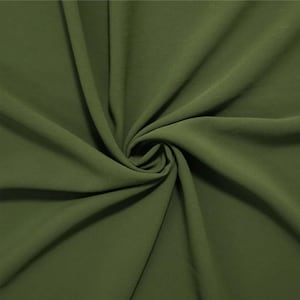 May include: A solid olive green fabric with a smooth, matte texture. The material is gathered in the center, creating deep, flowing folds and soft shadows that radiate outward, highlighting the consistent color and drape of the textile.