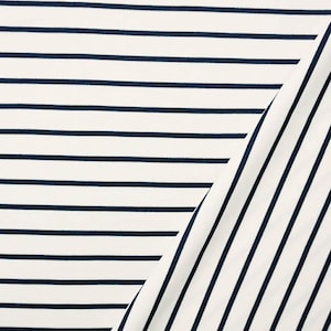 May include: A piece of fabric featuring a classic pattern of thin, dark navy blue horizontal stripes set against a crisp off-white background. The material is folded diagonally, revealing a section where the stripes transition to a vertical orientation.